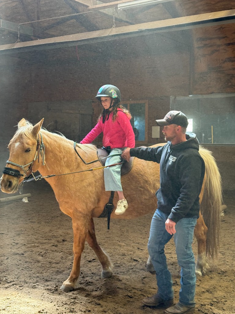 Beginner rider preparing for a first lesson at the ranch